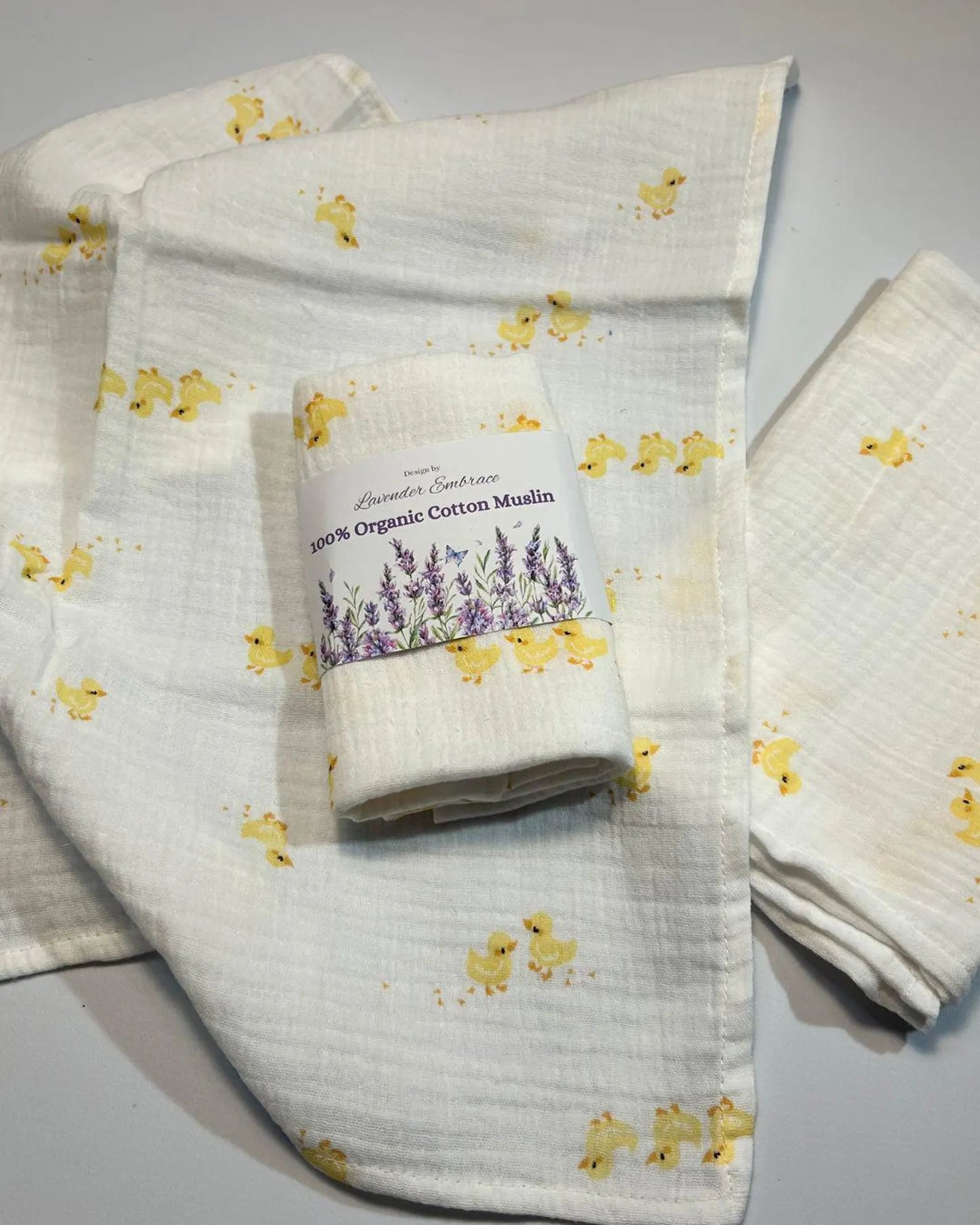 Roll of organic cotton muslin with duck pattern on a gray background