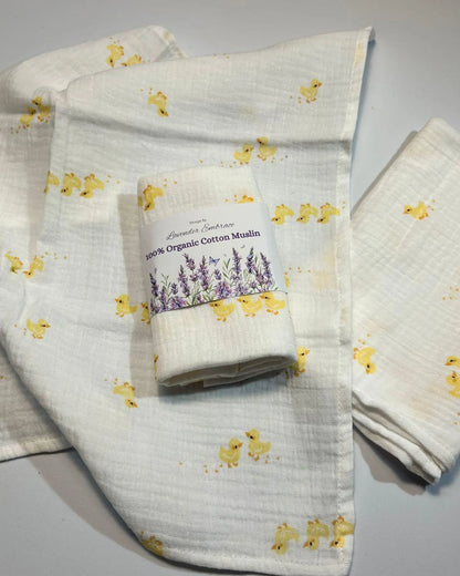 Roll of organic cotton muslin with duck pattern on a gray background
