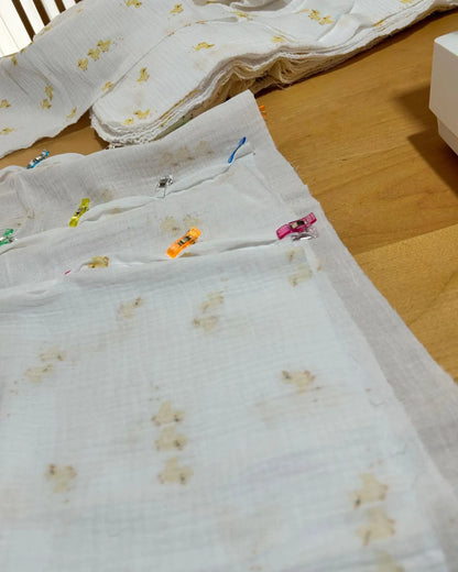 White fabric with yellow floral patterns on a wooden floor